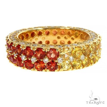 Yellow gold eternity ring with alternating red sapphires and white diamonds.