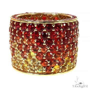Wide yellow gold eternity ring with red and orange fire sapphire gemstones in gradient rows.