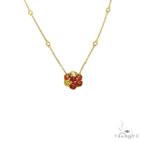Yellow gold chain necklace with a fiery sapphire and diamond flower pendant