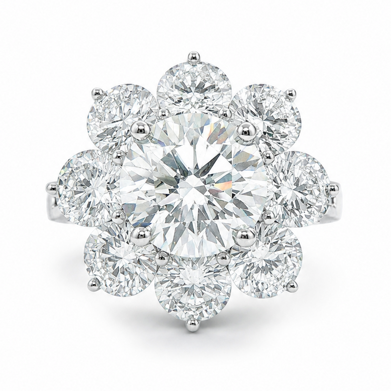 White gold floral cluster ring with round center diamond and surrounding petals of smaller diamonds