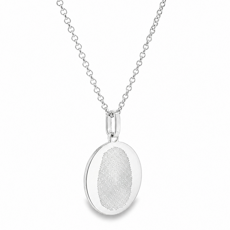 Silver oval pendant with fingerprint engraving on a delicate chain necklace.