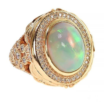 Yellow gold ring with oval galaxy opal center and diamond halo detailing.