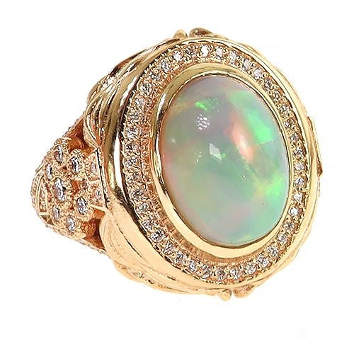 Yellow gold ring with oval galaxy opal center and diamond halo detailing