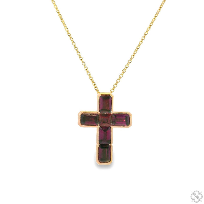Yellow gold cross pendant set with deep red garnet gemstones on delicate chain