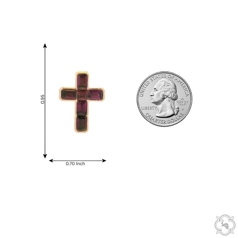 Small garnet gemstone cross pendant in rose gold setting, shown next to a quarter for size reference
