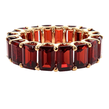 Yellow gold eternity ring with rectangular garnet emerald-cut gemstones.