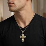 Gold diamond cross pendant featuring praying Jesus on a gold chain worn with black shirt.