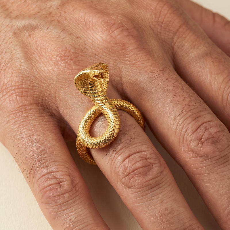 24k gold ring shaped like a coiled cobra with detailed scales and raised hood.