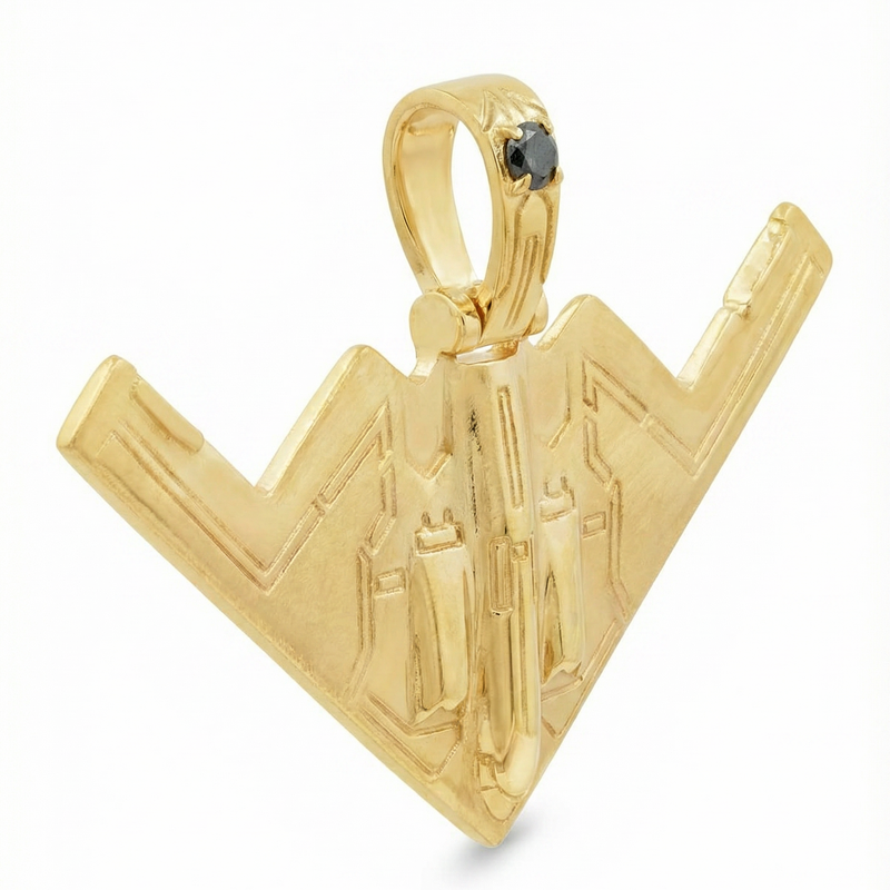 14k gold B-2 bomber pendant with engraved details and a small black diamond accent.