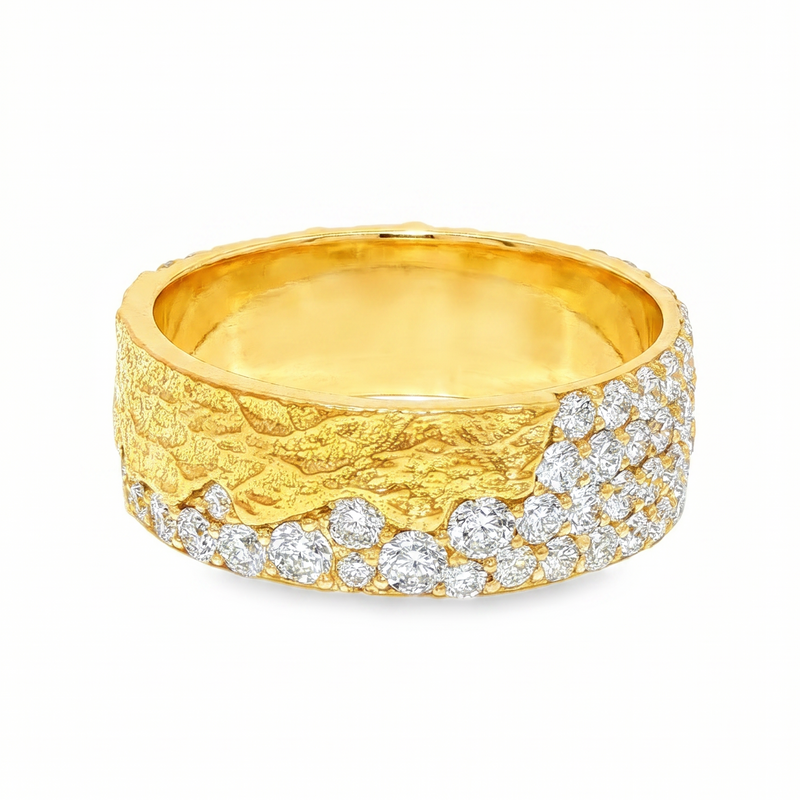 Yellow gold men's wedding band with textured surface and pave diamond accents.