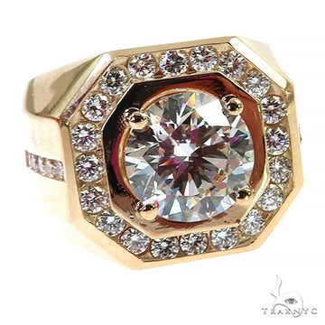 Yellow gold men’s ring with large center diamond and surrounding smaller diamonds.