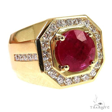 Yellow gold men's ring with large round ruby center and surrounding diamonds.