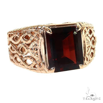 Gold men's ring with intricate filigree and large square garnet gemstone centerpiece.