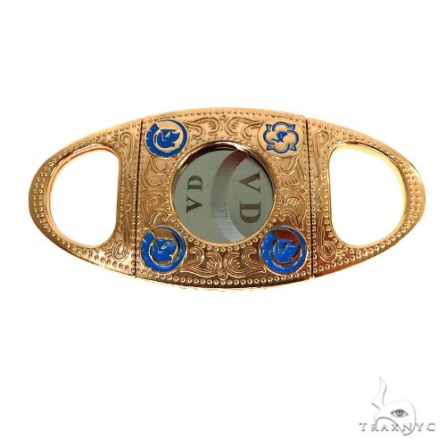 Gold cigar cutter smoking accessory – polished metal body, top-down angle showing blade mechanism