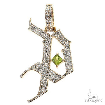 Yellow gold Gothic Old English initial pendant with pavé diamonds and green gemstone center.