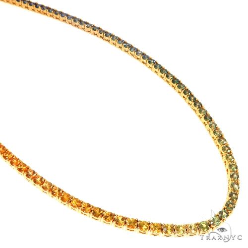 Graduated rainbow sapphire tennis chain with gold clasp, vibrant multicolored gemstones