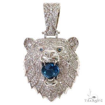 White gold grizzly bear pendant with blue topaz gemstone and diamond accents.