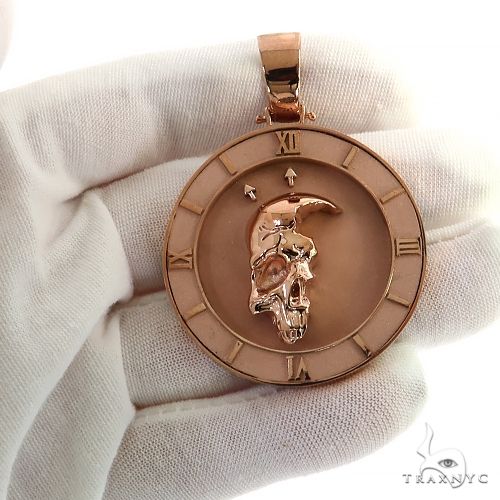 Rose gold pendant with half skull design inside a Roman numeral clock frame