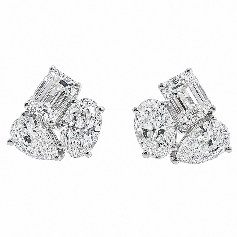 White gold cluster stud earrings with emerald, oval, and pear-shaped diamonds
