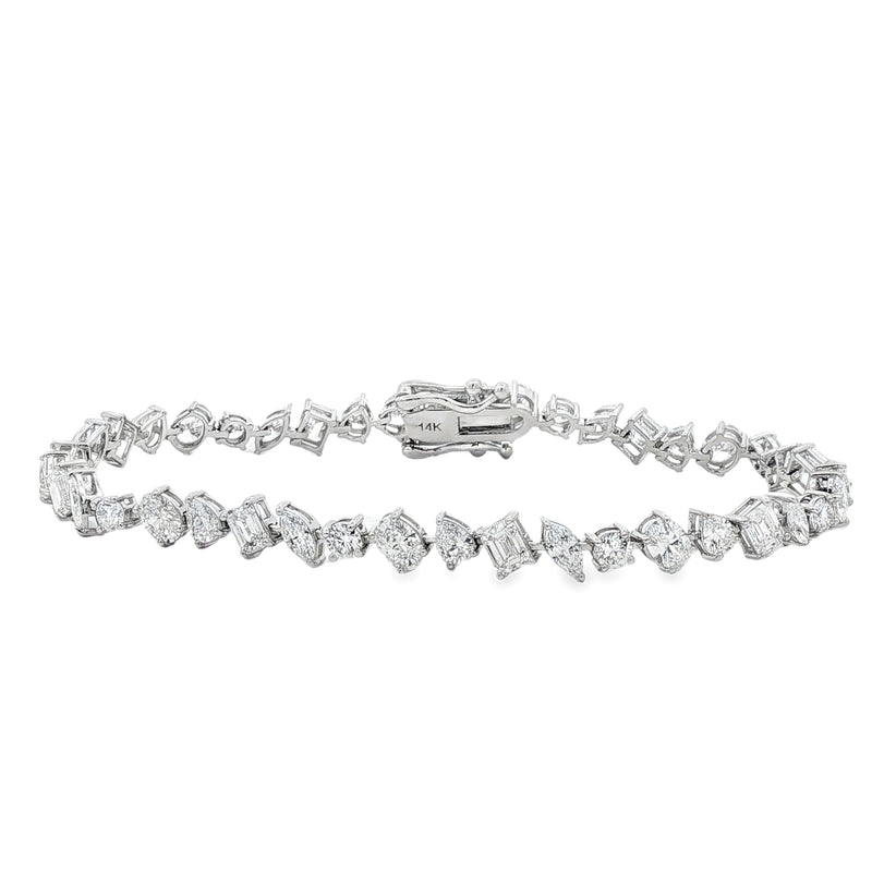 White gold bracelet with alternating round and square diamonds in geometric design.