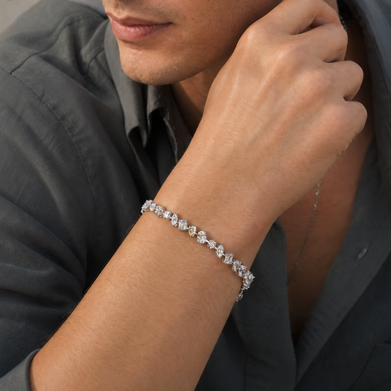 Silver diamond tennis bracelet with round-cut stones, sleek and elegant design on wrist.