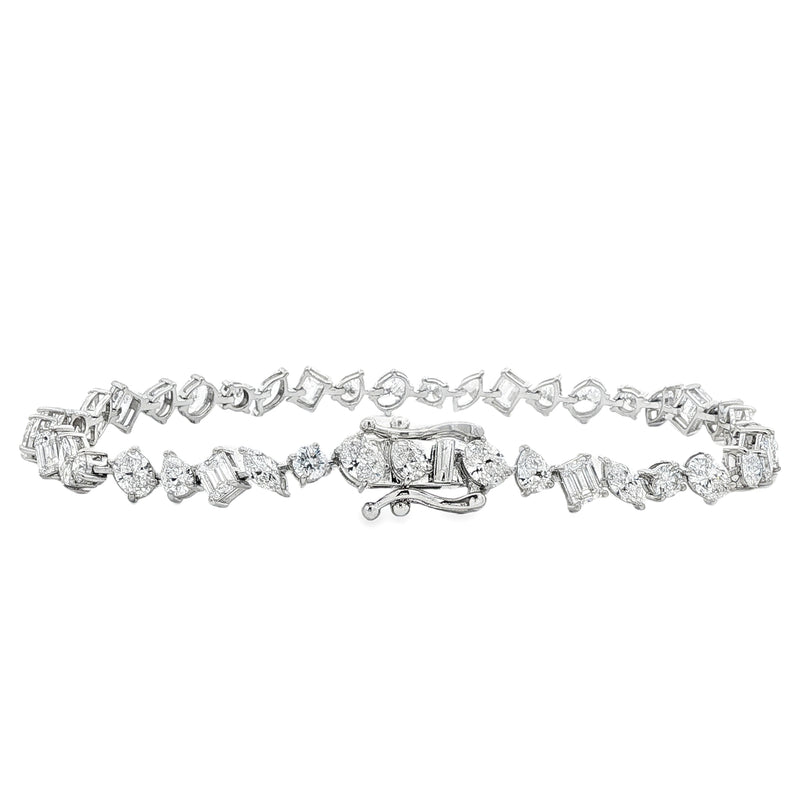 Silver bracelet with alternating diamond-shaped and round-cut diamonds, secure clasp closure.