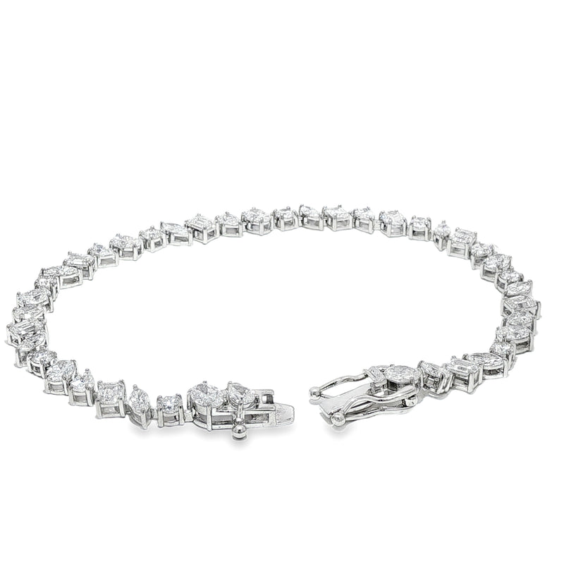 Silver bracelet with alternating square and round diamond settings and secure clasp.