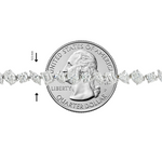 Delicate silver bracelet with alternating round and marquise diamonds, shown beside a quarter for scale.