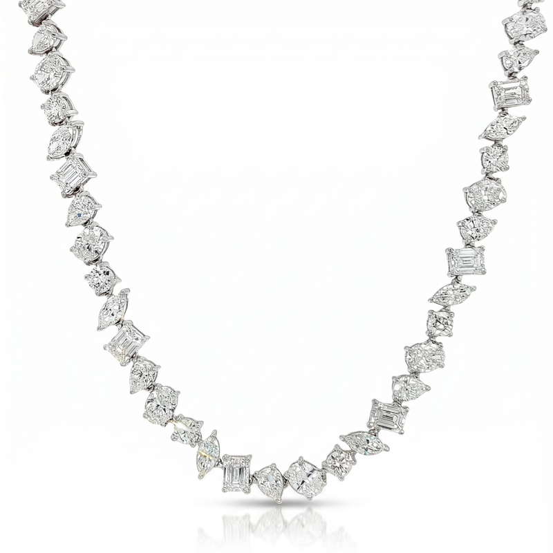 White gold necklace with alternating round and square diamonds in a chandelier style chain.