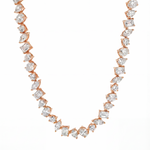 Rose gold chain necklace with alternating round and square sparkling diamonds.
