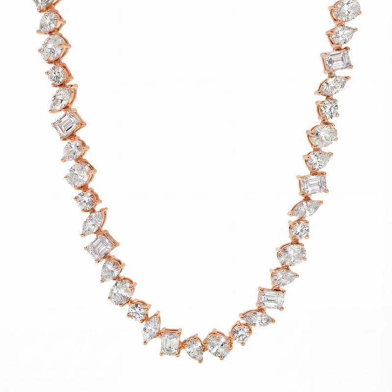 Rose gold chain necklace with alternating round and square sparkling diamonds.