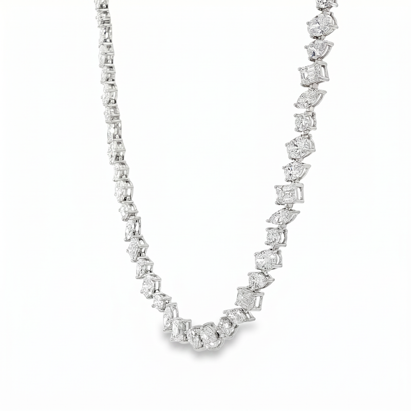 Silver chain necklace with alternating round and square diamonds in a symmetrical pattern.