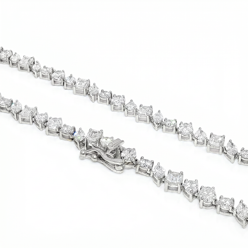 Silver diamond chain necklace with square-cut stones and secure clasp detailing.