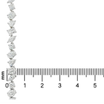 Silver chain necklace with alternating round and baguette diamonds above a millimeter ruler.