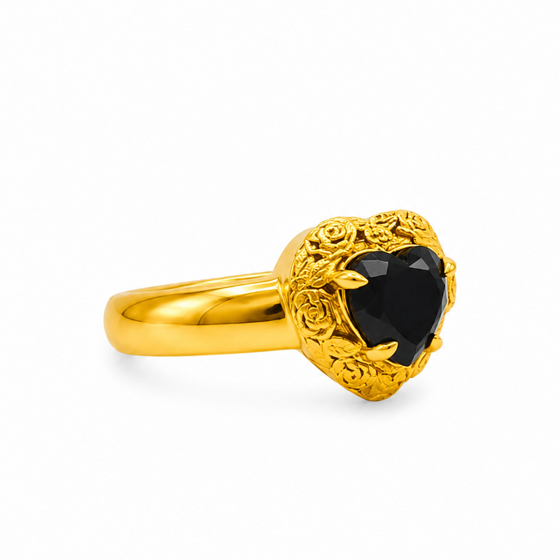 Gold heart-shaped black diamond ring with ornate floral filigree gold frame and prong setting

