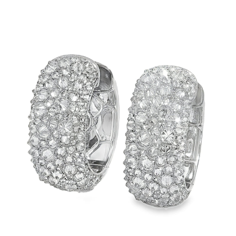 Silver hoop earrings with inverted mosaic pattern of clustered sparkling diamonds.