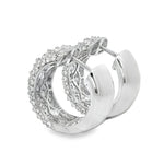 Silver hoop earrings with inverted mosaic diamond pattern and polished interior surface.