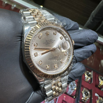 Luxury watch with diamond-studded face held by a gloved hand