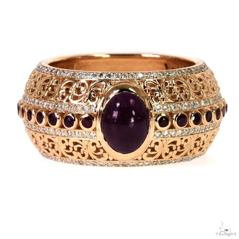 Rose gold ring with central oval ruby, smaller round rubies, and intricate filigree detailing