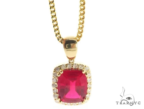Yellow gold chain with cushion-cut red gemstone pendant surrounded by small diamonds