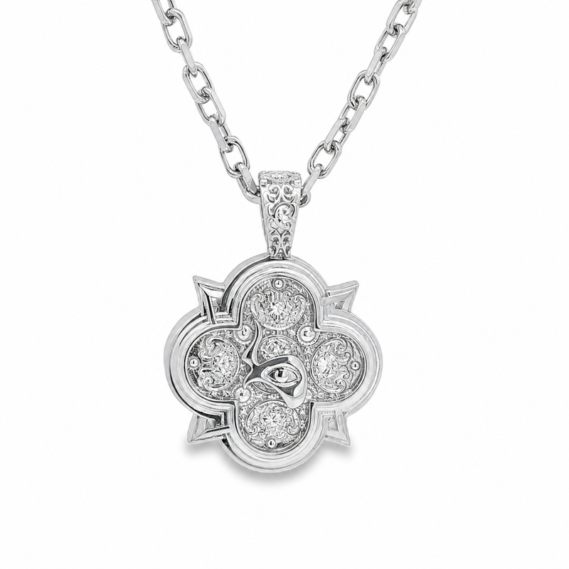 Silver pendant necklace with floral design and embedded sparkling stones on silver chain.