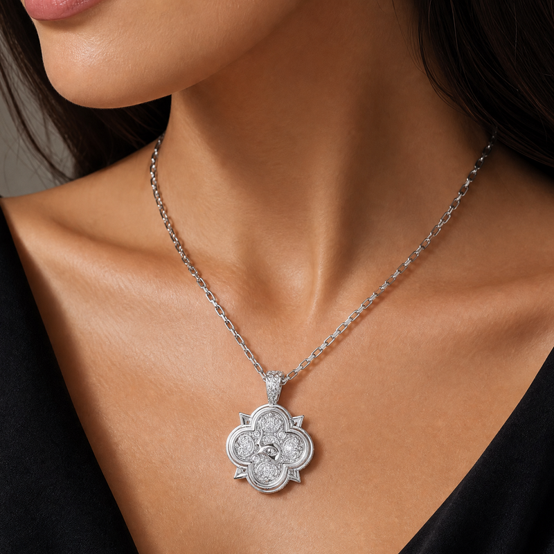 Silver rope chain necklace with a flower-shaped pendant featuring intricate detailing.