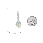 Silver pendant with opal stone shaped like an eagle claw, accented with small diamonds.