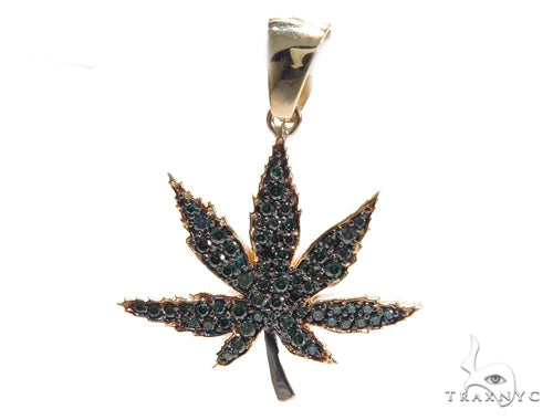 Yellow gold pendant shaped like a maple leaf with black diamond accents