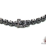 Black diamond chain necklace with a matching cross pendant in a dark metallic finish.