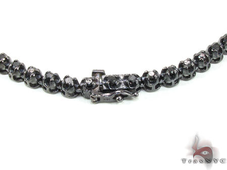 Black diamond chain necklace with a matching cross pendant in a dark metallic finish.