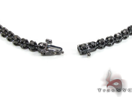 Black diamond chain necklace with a matching cross pendant in a dark metallic finish.