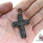 Black diamond chain necklace with a matching cross pendant in a dark metallic finish.