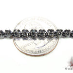 Black diamond chain necklace with a matching cross pendant in a dark metallic finish.