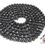 Black diamond chain necklace with a matching cross pendant in a dark metallic finish.